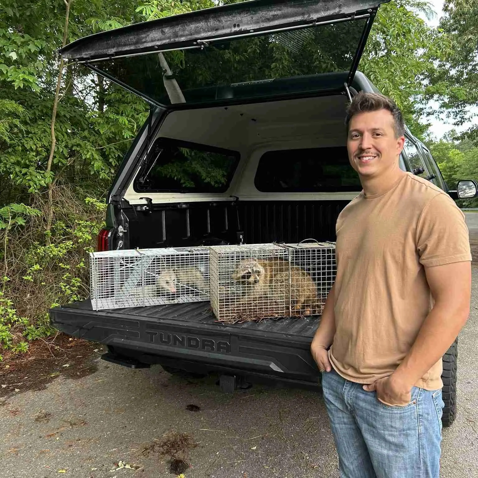 Owner of wills wildlife standing by work truck